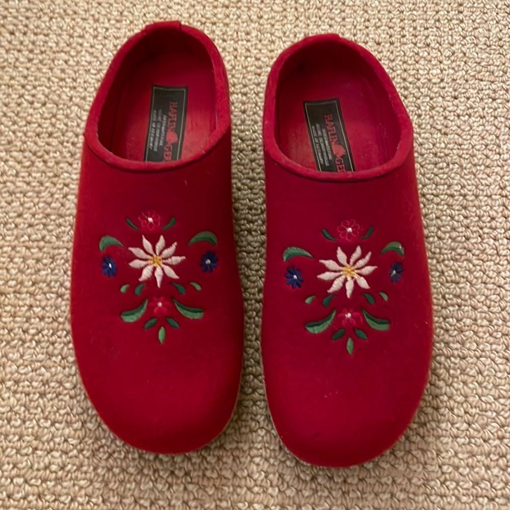 Haflinger red felt clogs with embroidered tops and cork soles.